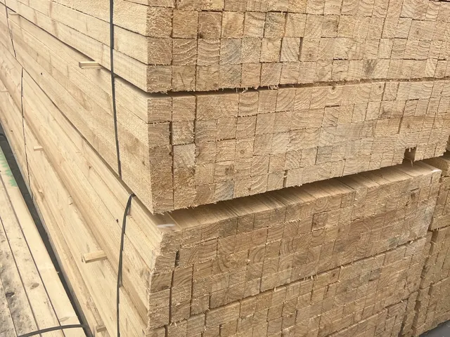 End grain of strapped sawn whitewood bundles stacked in the yard